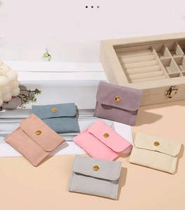 Macro shot of colorful microfiber jewelry pouches with elegant gold snap buttons