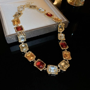 Detail of luxury vintage choker with square amber and red gems in a grey display box