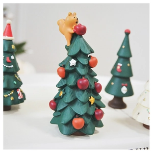 Detail of resin Christmas tree with cute squirrel topper and apple decorations