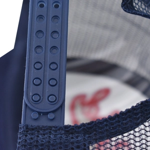 Detail of adjustable snapback closure on navy blue mesh baseball cap with double row holes