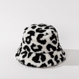 Close-up detail of plush faux fur leopard print bucket hat texture for winter