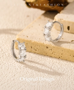 Close-up of S925 silver hoop earrings featuring three sparkling moissanite stones