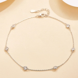 Detailed view of silver chain with bezel-set round zircons and adjustable lobster clasp