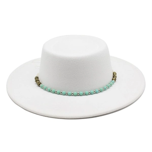 Close-up of white felt boater hat featuring a turquoise and gold beaded decorative band