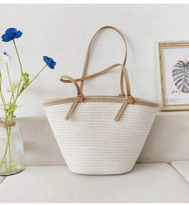 Detail of hand-woven cotton rope tote bag with khaki trim and knotted leather handles