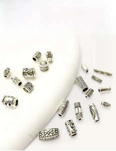 Detail view of retro silver spacers with embossed patterns for DIY jewelry making