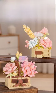 Detail of buildable flower basket toy with pink roses and yellow grain floral blocks