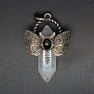 Macro detail of vintage dragonfly pendant with hexagonal crystal and black stone inlay