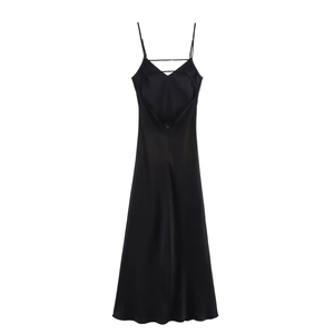 Detail of the cross-back straps and silky satin texture on this black midi dress