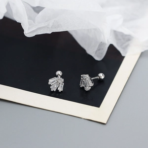 Macro detail of S925 silver stud earrings with baguette cubic zirconia and screw ball backs