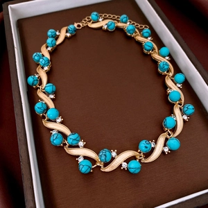 Macro shot of vintage gold turquoise necklace with rhinestones in a brown jewelry box