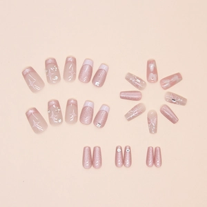 Pink cat-eye press-on nails with star patterns, butterfly designs and rhinestones