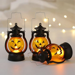 Three vintage Halloween lanterns with pumpkin face patterns and warm LED glow
