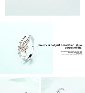 Detail of silver and rose gold infinity heart ring with shimmering crystal accents