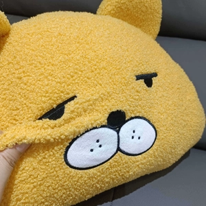 Close-up of fluffy yellow lamb wool plush pillow showing soft texture and embroidery