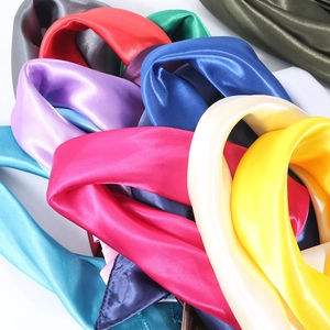 Vibrant 60cm solid color silk neck scarves in multiple shades on a clean white background