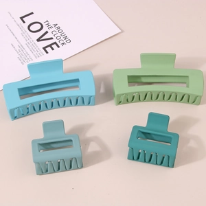 Set of four matte rectangle hair claws in assorted blue and green tones and sizes