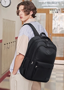 Close-up of black multi-compartment backpack with durable fabric and side mesh pocket