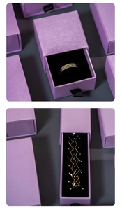 Detail of purple drawer jewelry box with matte texture and black flocked interior lining