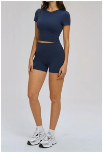 Detail of dark blue yoga set with high waist shorts and slim short sleeve sports top
