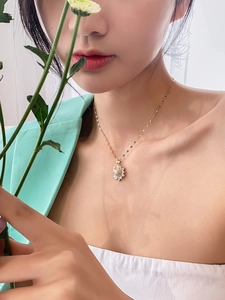 Golden sunflower necklace with zircon petals worn by a model in fresh style clothing