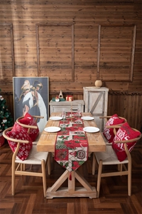 Detail of Christmas table runner with red and green jacquard patterns and festive tassels