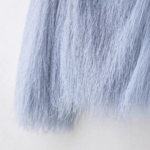 Fashionable light blue fringe jacket showing soft texture and detailed tassel fibers
