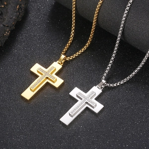 Macro shot of dual-layer gold and silver stainless steel cross pendants with micro diamonds