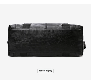 Detail of reinforced bottom with cross-stitch straps on black PU leather travel bag