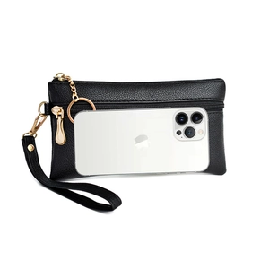 Detail of black pebbled leather clutch showing size compared to a smartphone