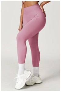 Detailed close-up of wide ribbed high waistband on seamless peach-lift yoga leggings