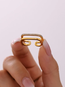 Macro detail of gold double-layered open ring with sparkling white zircon pave stones