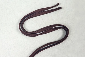 Detailed close-up of dark brown ribbed knit strap showing fine stitching and fabric texture