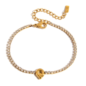 Close-up of 18K gold-plated tennis bracelet with letter Q pendant and sparkling crystals
