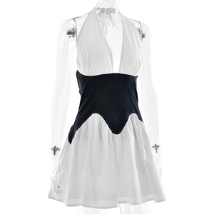 Detail of color-block halter dress featuring deep V-neckline and black waist contrast