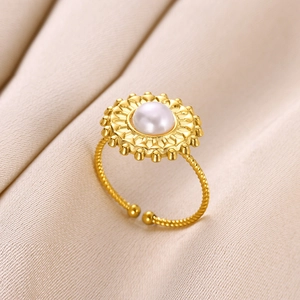 Gold stainless steel ocean ring with twisted band and round pearl in floral setting