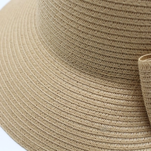Macro shot of tightly woven straw texture and spiral pattern on a summer sun hat