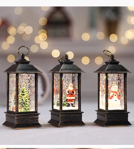 Three bronze Christmas lanterns with snowmen and Santas in a warm festive setting