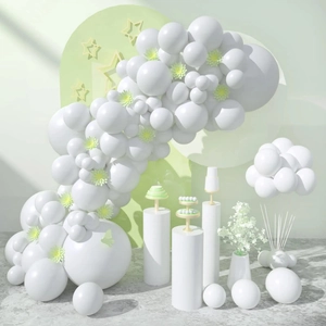 Matte white balloon arch kit with decorative pedestals for birthday party setup