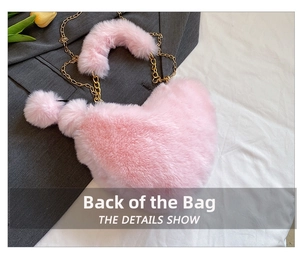 Back view of heart-shaped pink faux fur crossbody bag with golden chain and pompom detail