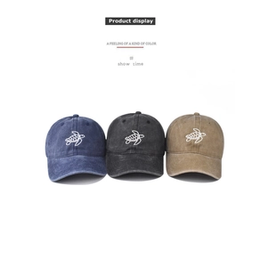 Detailed row of washed cotton baseball caps with white sea turtle embroidery in three colors