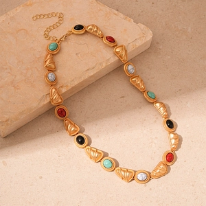 Close-up of vintage geometric necklace with colorful faux stones and gold-tone links