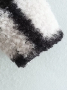 Close-up of black and white plaid plush fabric texture for long lapel coat