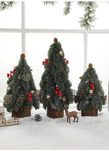 Mini Christmas trees with red berries and pine cones on natural wood bases for table decor
