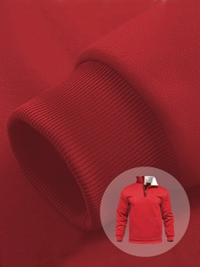 Detailed view of red hoodie showing rib-knit cuffs and premium fabric texture