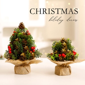 Mini Christmas trees set with red berries and pine cones on rustic burlap bases