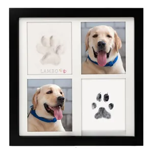Detail of DIY pet memorial photo frame with paw prints and dog photos in black frame