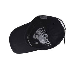 Detail view of the black cotton baseball cap interior featuring a 100% cotton wash label
