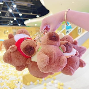 Close-up of cute plush capybara keychains with various colorful neck accessories
