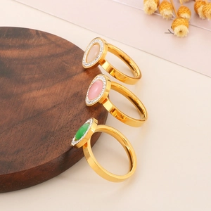 Detailed close-up of oval quartz rings in gold with sparkling rhinestone halo accents